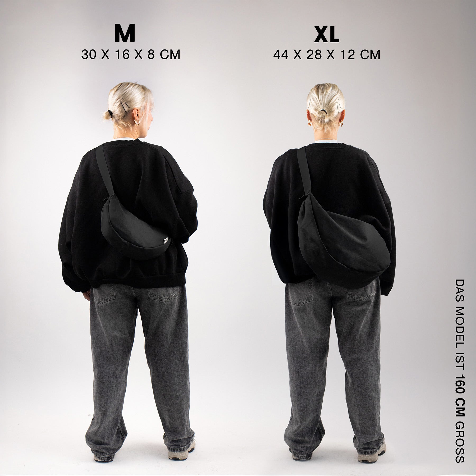 Moon bag XL schwarz indoor frau steht mit dem ruecken zur kamera traegt weite jeans