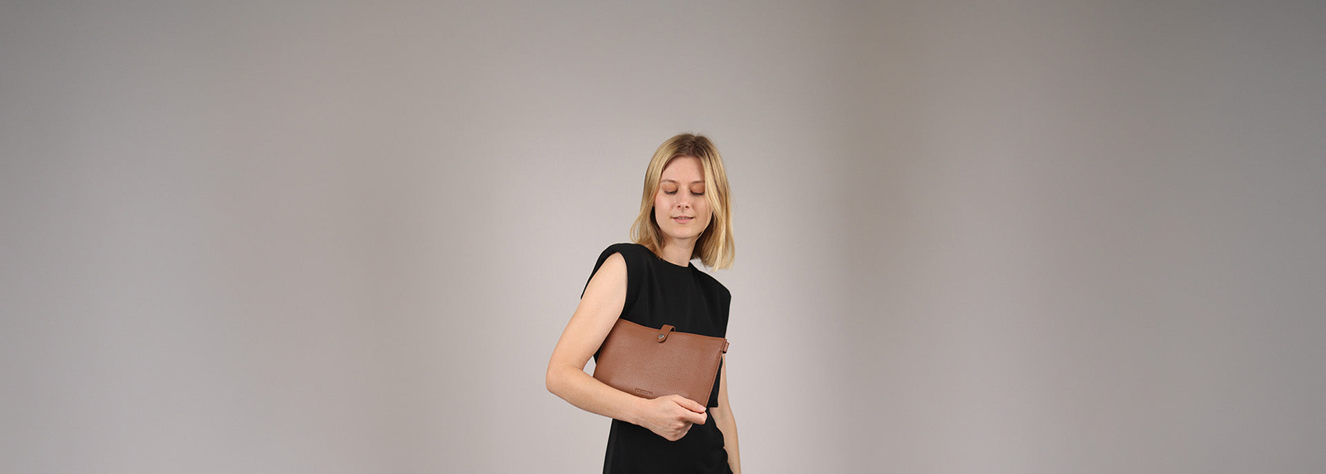 Tablethuelle aus Leder in Hand von Model im Studio