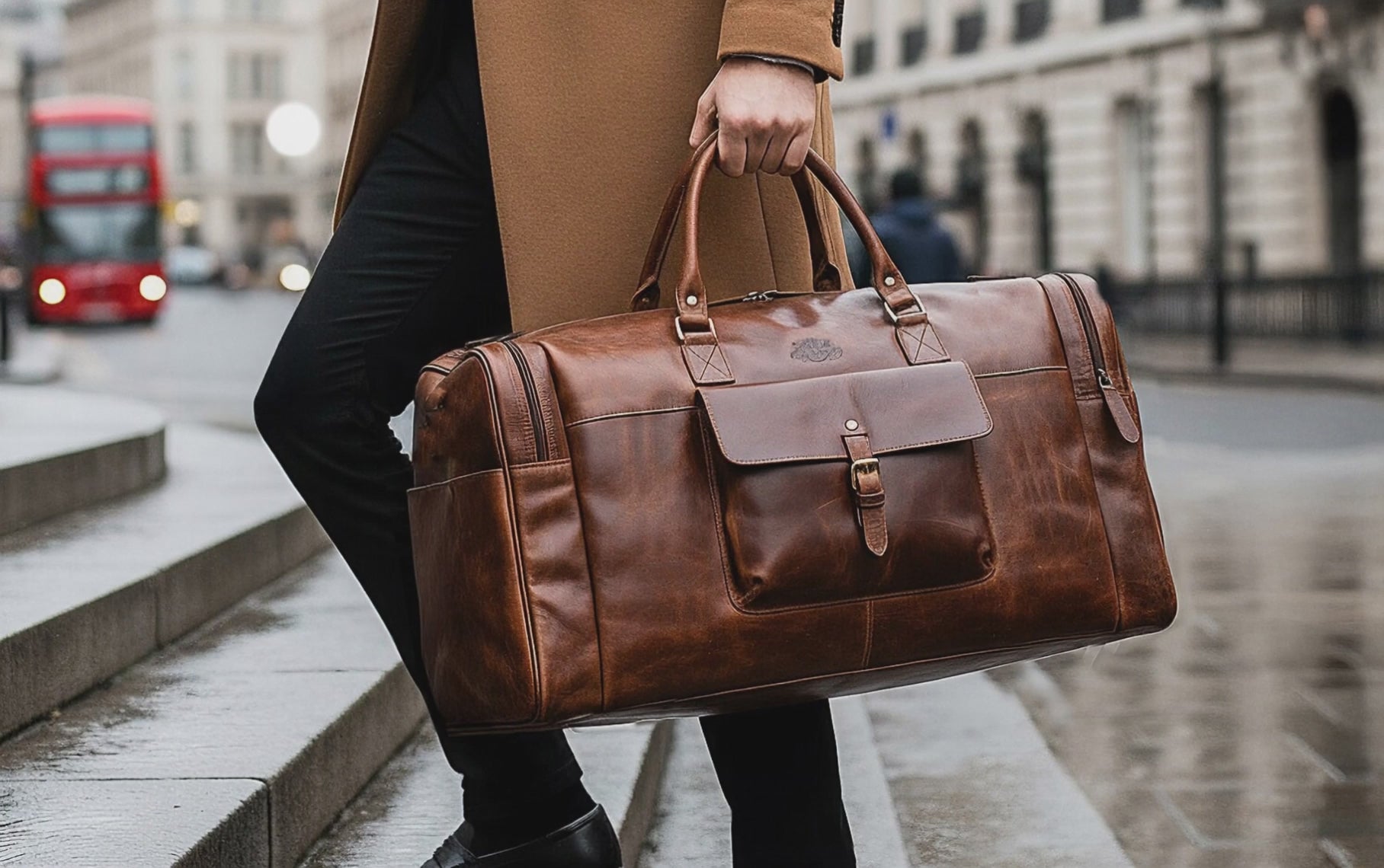 Cinematic wide shot of a stylish man ascending a series of glistening wet stone steps, coffee cup in one hand and a chic brown leather trave bag in the other. The bustling cityscape buzzes with blurred figures and a striking red double-decker bus, amplifying the energetic urban vibe.