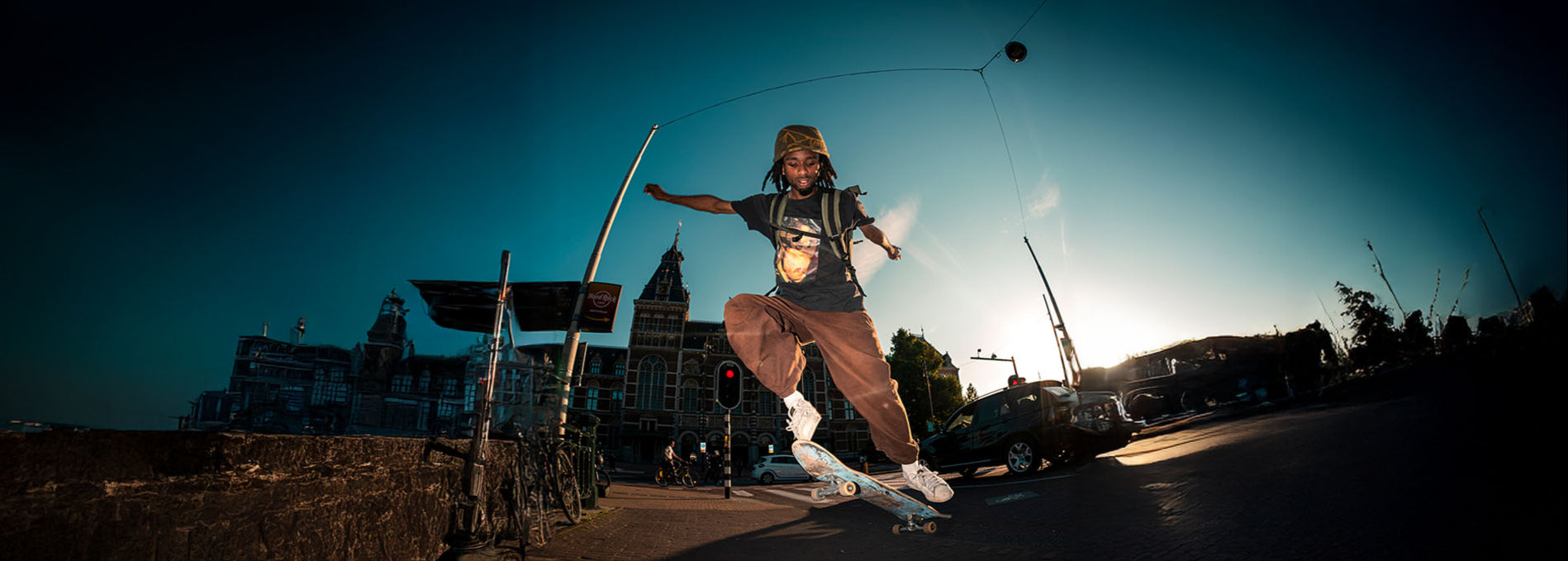 Sons of Aloha Rucksack auf Mann der mit Skateboard einen Ollie macht